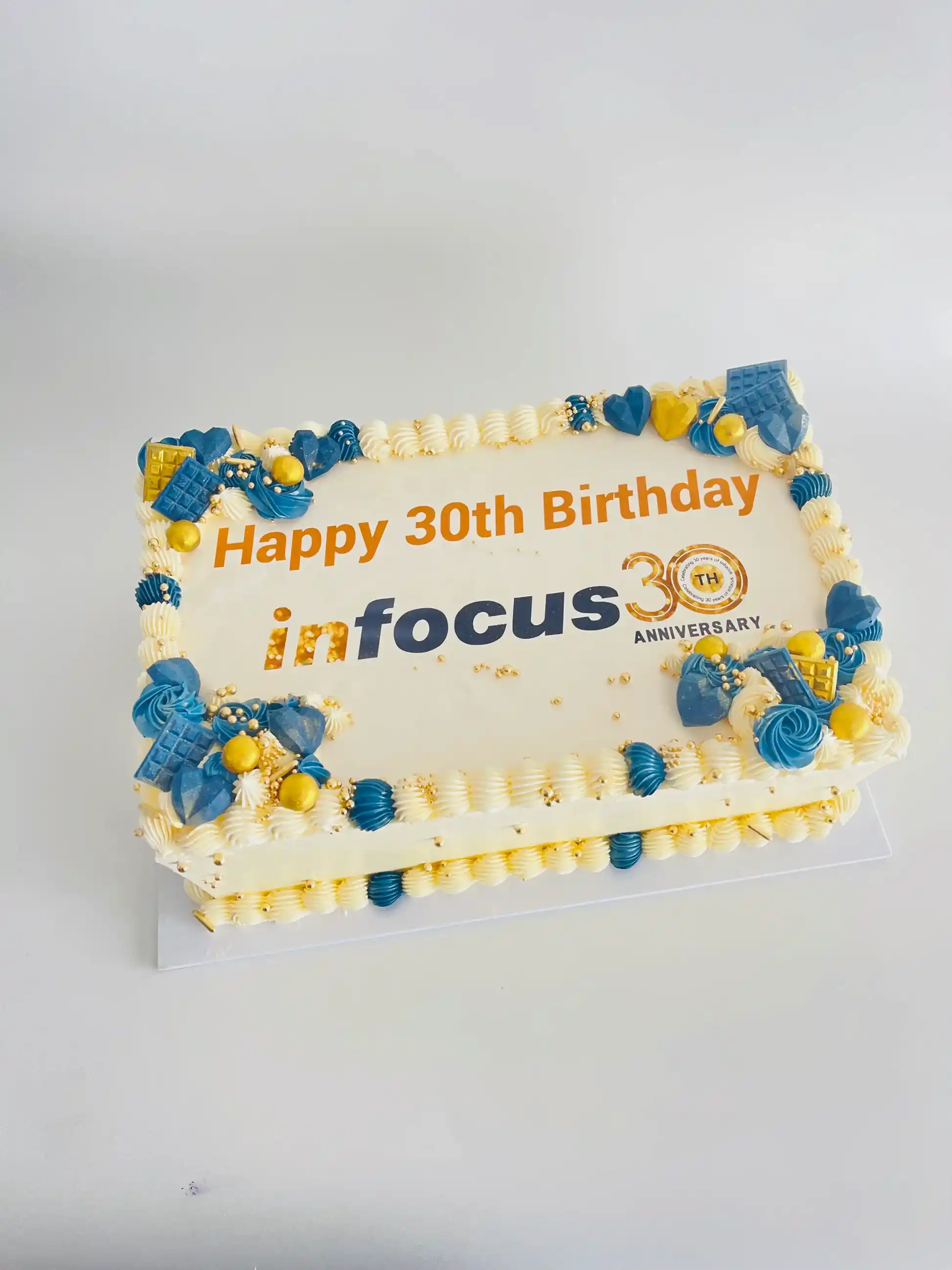 rectangle cake with office logo, message and matching decorations
