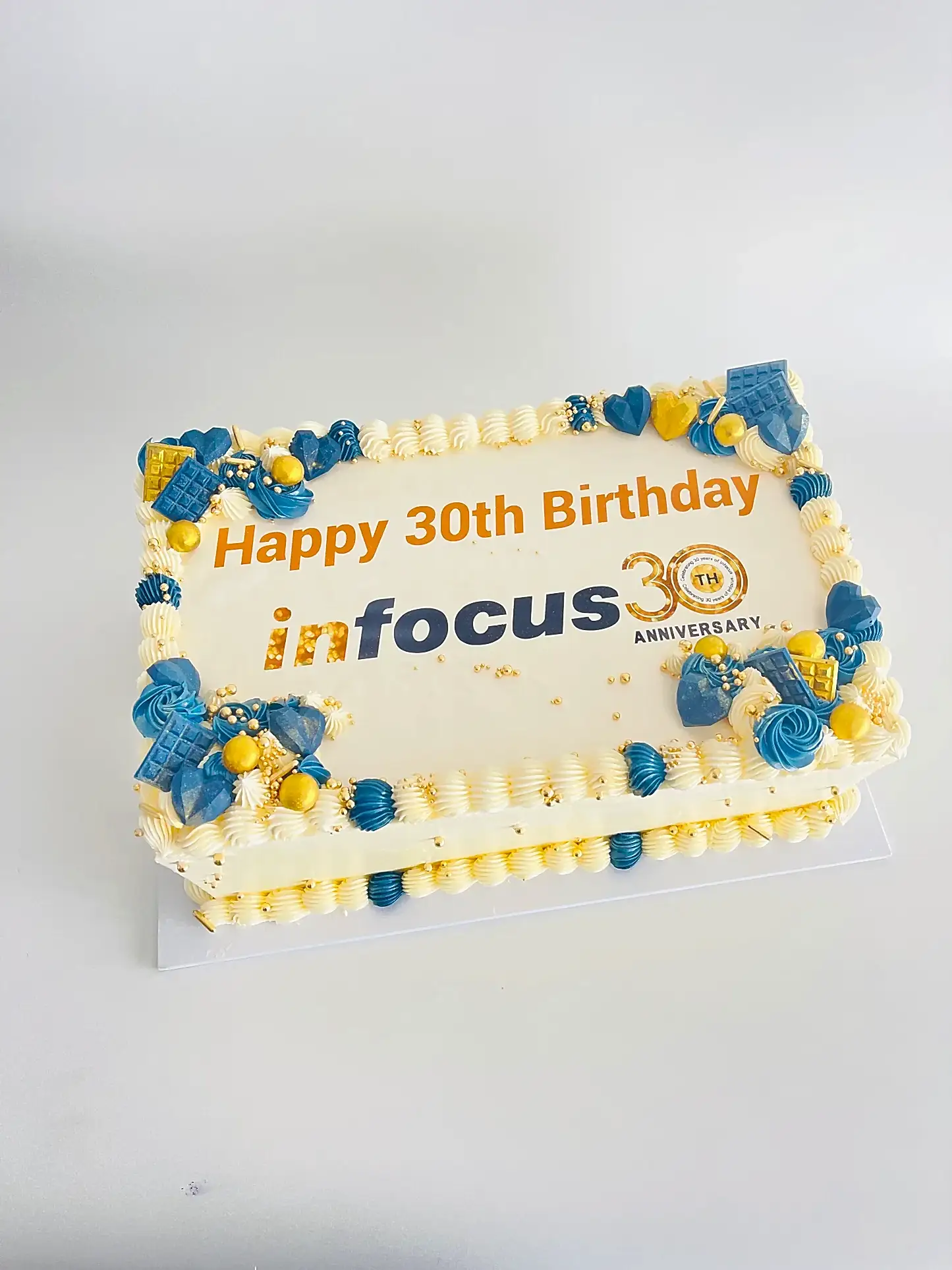 rectangle cake with office logo, message and matching decorations