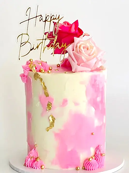Pretty cake with pink finishes and pink roses perfect for any celebration or a gift